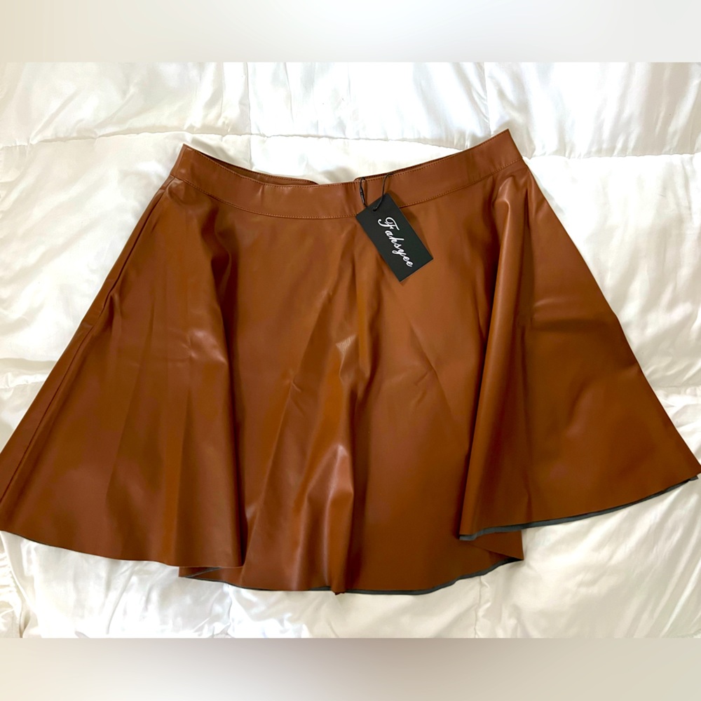 Faux leather skirt. Never worn. Gorgeous camel color. Slightly pleated.